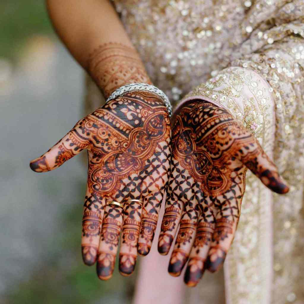 the-indian-pre-wedding-Mehndi-ceremony-involves-applying-intricate-henna-designs-to-the-bride's-hands-and-feet