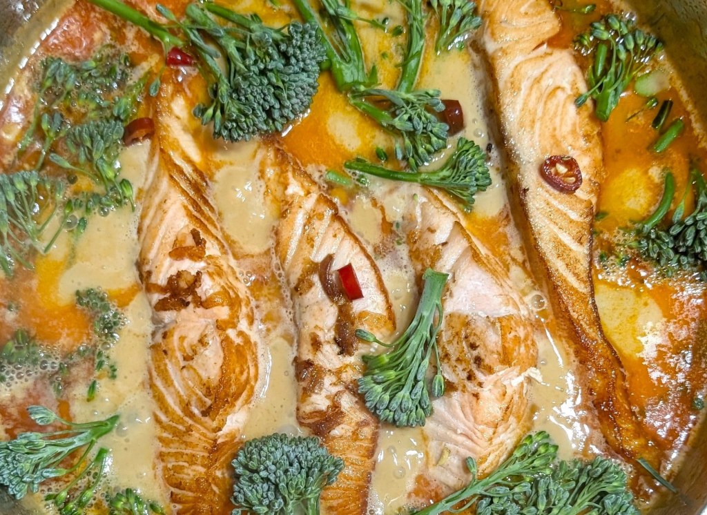 Quick-Thai-Red-Curry-Salmon-Recipe-salmon-fillets-simmered in-rich-creamy-spicy-coconut-milk-flavored-with-red-curry-paste-ginger-chilli-and-lime.