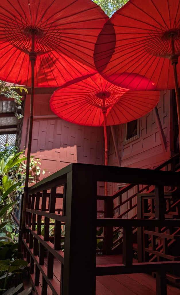Red umbrellas at Jim Thompson House