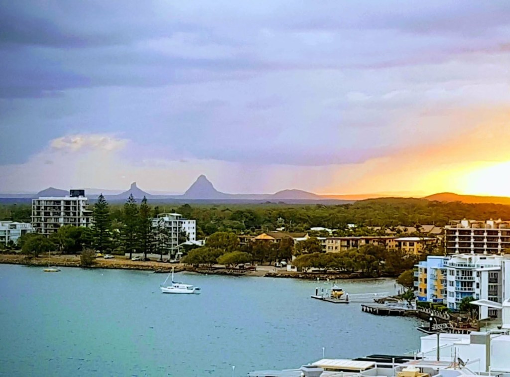 The majestic peaks of the Glasshouse Mountains rise up behind the scenic coastal city of Caloundra on the Sunshine Coast